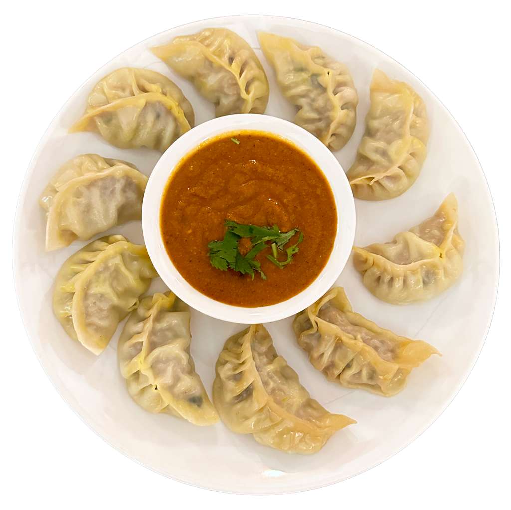 Steamed chicken momos served with tomato chutney