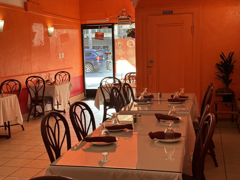 Dining tables with white tablecloths and place settings